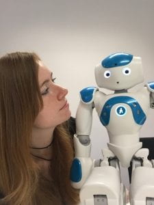 Katie Winkle with a small humanoid robot (Nao)