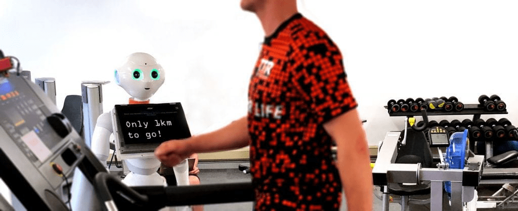 Man on treadmill and humanoid robot with 'only 1km to go' display