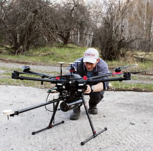 Kieran checks the drone before take-off in the village of Buriakivka, near Chernobyl